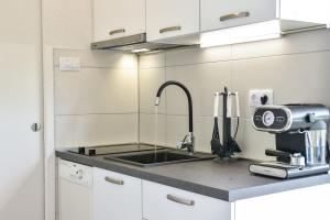 a kitchen with a sink and a mixer at House Lila Jacuzzy in Drvenik Mali