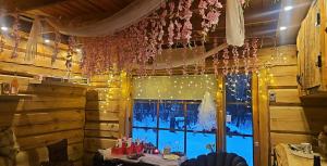 a room with a table and a window with lights at Tammetalu puhkemaja in Nõmme