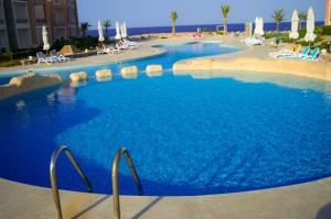 a large pool with blue water in a resort at شاليه in Marsa Alam