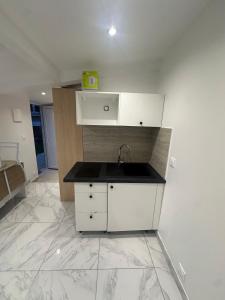 a kitchen with a sink and a counter at Maison Inviduelle in Aulnay-sous-Bois +3 photos