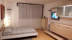 a bedroom with a bed and a television in it at venice la pergola n 3 in Spinea
