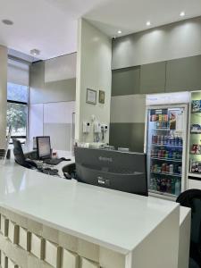 an office with a counter with a refrigerator at Flat 609 - Comfort Hotel Taguatinga - Particular in Brasília