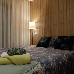 a bedroom with a large bed and a lamp at Moimenta Guest House in Mindelo +115 photos