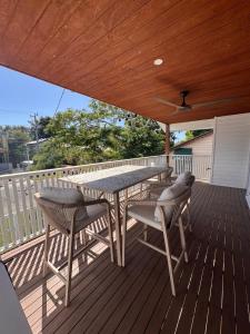 a patio with a table and chairs on a deck at Spacious Private 2BR Guest Suite in Gold Coast