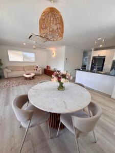 a living room with a white table and chairs at Spacious Private 2BR Guest Suite in Gold Coast