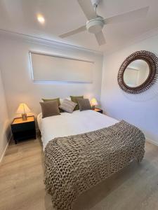 a bedroom with a large bed and a mirror at Spacious Private 2BR Guest Suite in Gold Coast