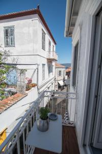 a balcony with a table with a plant on it at Almond Suite in Hydra