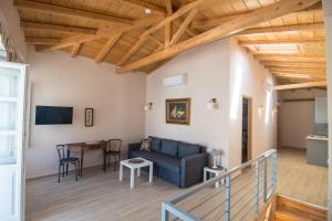 a living room with a couch and a table at Almond Suite in Hydra +7 photos