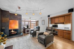 a living room with a fireplace and a kitchen at 1777 Larimer 2211 in Denver