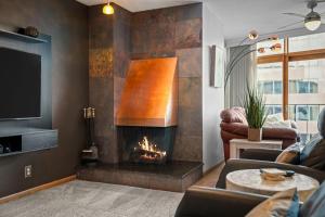 a living room with a fireplace and a tv at 1777 Larimer 2211 in Denver