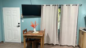 a kitchen with a table and a white curtain at Churros Apartahotel in La Libertad