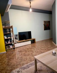 a living room with a flat screen tv on a wall at M&L apartment Large in Perea