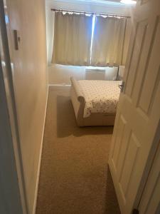 a small bedroom with a bed and a window at Edney Court in Reading