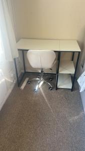 an office desk with a white chair under it at Edney Court in Reading