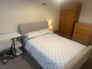 a small bedroom with a bed and a desk at Edney Court in Reading