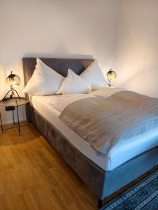 a bedroom with a bed with two lamps on it at Apartment Central Mutters Innsbruck in Innsbruck