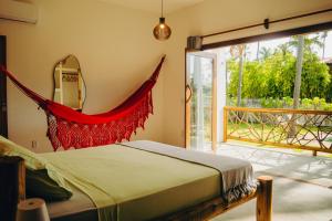 a bedroom with a bed and a large window at Casa de Coco Icarai in Icaraí +44 photos