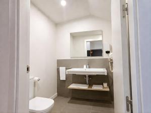a bathroom with a sink and a toilet at Eibarooms in Éibar +53 photos