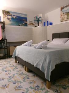 a bedroom with a bed with towels on it at Capri Coral Home in Anacapri +52 photos