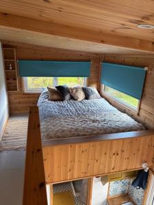 a bed in the middle of a tiny house at Tiny Home - Huge Views - Coastal - Surf in Sligo