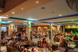a group of people sitting at tables in a restaurant at LA CARETTA S1 in Alikanas +10 photos