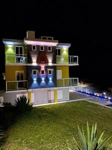 a building with lights on the side of it at night at Casa BB&Djassi - SUITES in Ponta do Sol