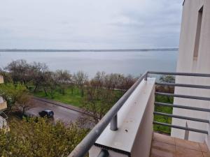 a balcony with a view of a body of water at Vila Siana in Mamaia