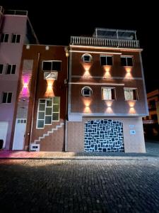 a building with lights on the side of it at Casa BB&Djassi - ROOMS in Ponta do Sol