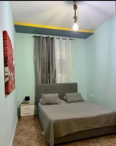 a bedroom with a bed with a yellow stripe on the ceiling at M&L apartment Large in Perea