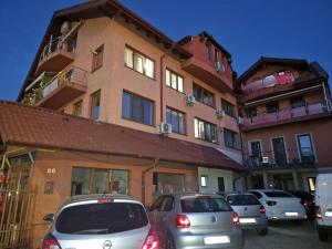 a group of cars parked in front of a building at Dixi Studio in Timişoara