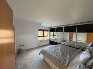 a bedroom with a large bed and a window at Relax In Belfast in Belfast +1 photo