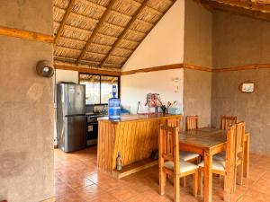 a kitchen with a table and a refrigerator at Pan de Azúcar Lodge in Ciudad de Chañaral