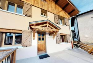 a building with a door with a sign on it at Chalet De Manou - Chalet individuel rénové pour 12 personnes avec sauna dans les 3 Vallées MAE-3694 in Saint-Martin-de-Belleville