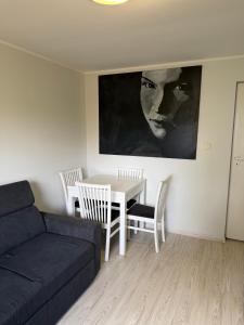 a living room with a couch and a table at Mała Tyczkówka in Stężyca