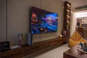 a living room with a flat screen tv on a wall at Copper Living in Muscat +38 photos