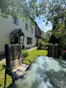a table and chairs with a table and a house at Apartament nad rzeką 2 in Kowary