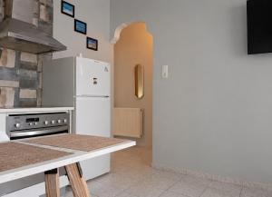 a kitchen with a white refrigerator and a stove at Petit house Vrachati in Vrachati