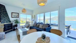 a living room with a couch and a table at The Cliffs - ArealongaBeach in O Vicedo