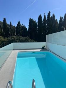 a swimming pool on the roof of a house at Casa Roca Maura in L'Estartit