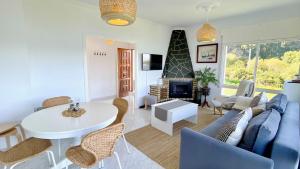 a living room with a blue couch and a table at The Cliffs - ArealongaBeach in O Vicedo