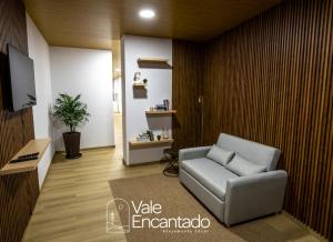 a living room with a couch and a tv at Vale Encantado in Parada de Ester