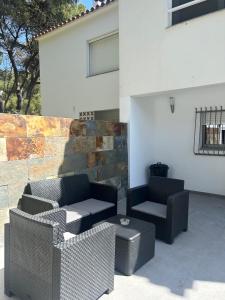 a patio with two couches and a table at Casa Roca Maura in L'Estartit