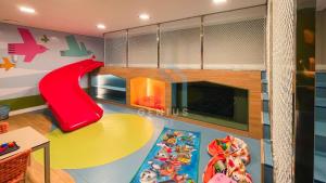 a childrens play room with a slide and a play floor at Move Tambaú Genius Flats in João Pessoa +22 photos