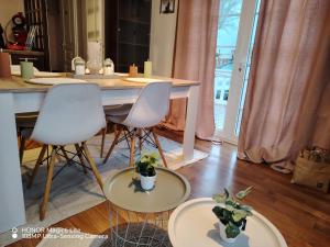 a room with a table and two chairs with plants at Camping le petit RIO in Noyelles-sur-Mer