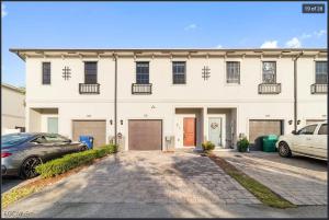 a white house with cars parked in front of it at Casa Lux in Florida City