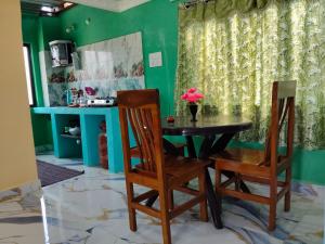 a dining room with a table and two chairs at Auro Delight - Near Auroville in Pondicherry in Villupuram
