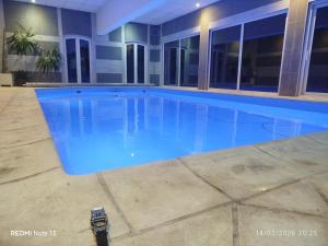a large swimming pool in a building at Gîte "fils de laine" Piscine chauffée interieure et Sauna ouverts toute l'année in Celles-sur-Plaine