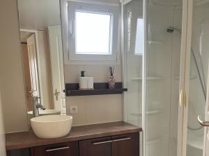 a bathroom with a sink and a shower at Camping le petit RIO in Noyelles-sur-Mer