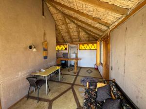 a room with a table and chairs in a room at Pan de Azúcar Lodge in Ciudad de Chañaral +54 photos