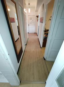 a hallway in a house with wood floors and a mirror at Enjoy Pirineos in Huesca